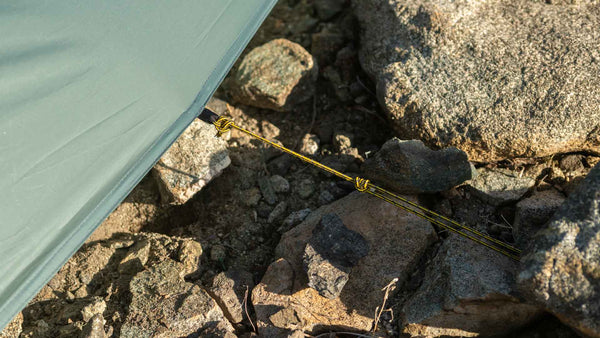 Tarptent ProTrek corner tie-out staked on rock – detail