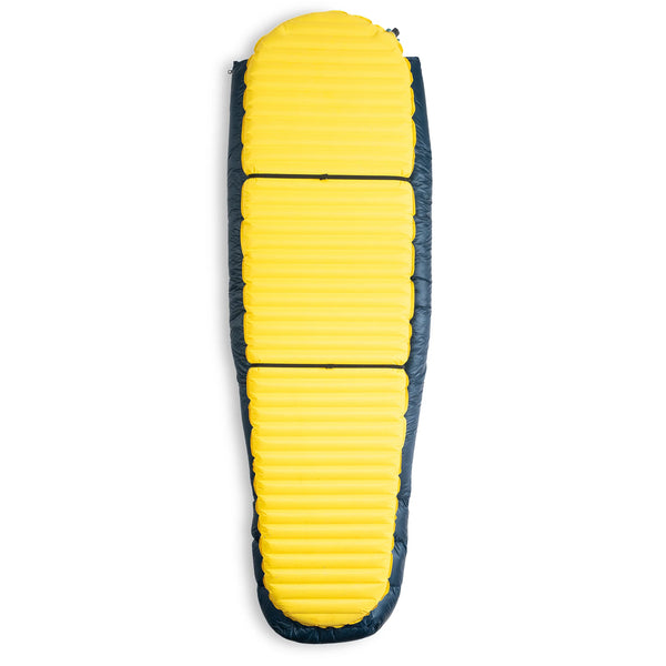 Hyperlite Mountain Gear 20-Degree Quilt shown on a yellow sleeping pad