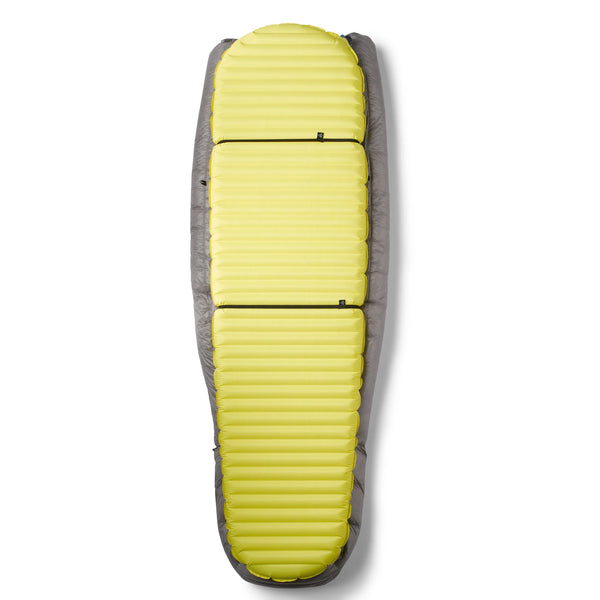 Hyperlite Mountain Gear 20-Degree Quilt shown on a yellow sleeping pad