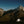 Gossamer Gear The One V2 pitched and lit up at night against a starry mountain skyline