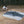 Gossamer Gear Polycro Ground Cloth laid out under a packed tent, trekking poles nearby