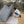 Gossamer Gear Polycro Ground Cloth under a pitched tent, hiker adjusting the corner stake